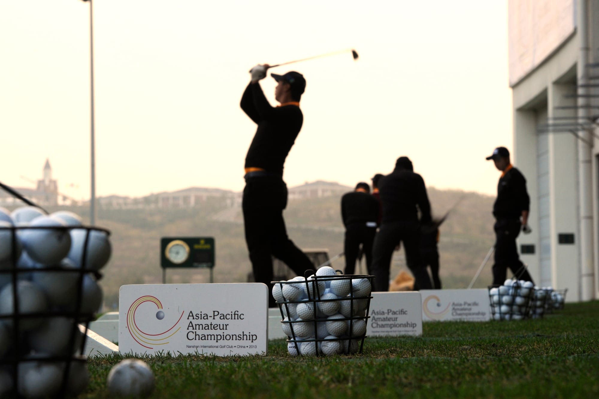 Participants warming-up at Nanshan International Golf Club's driving range.