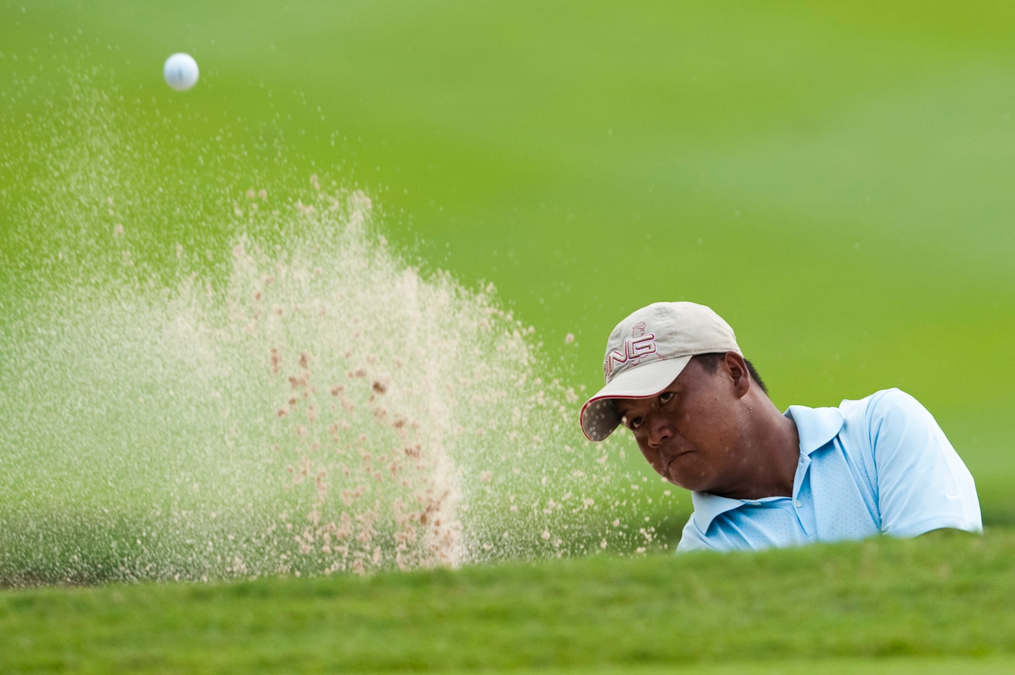 Mhark Fernando of the Philippines splashes out of a bunker. He finished equal 22nd.