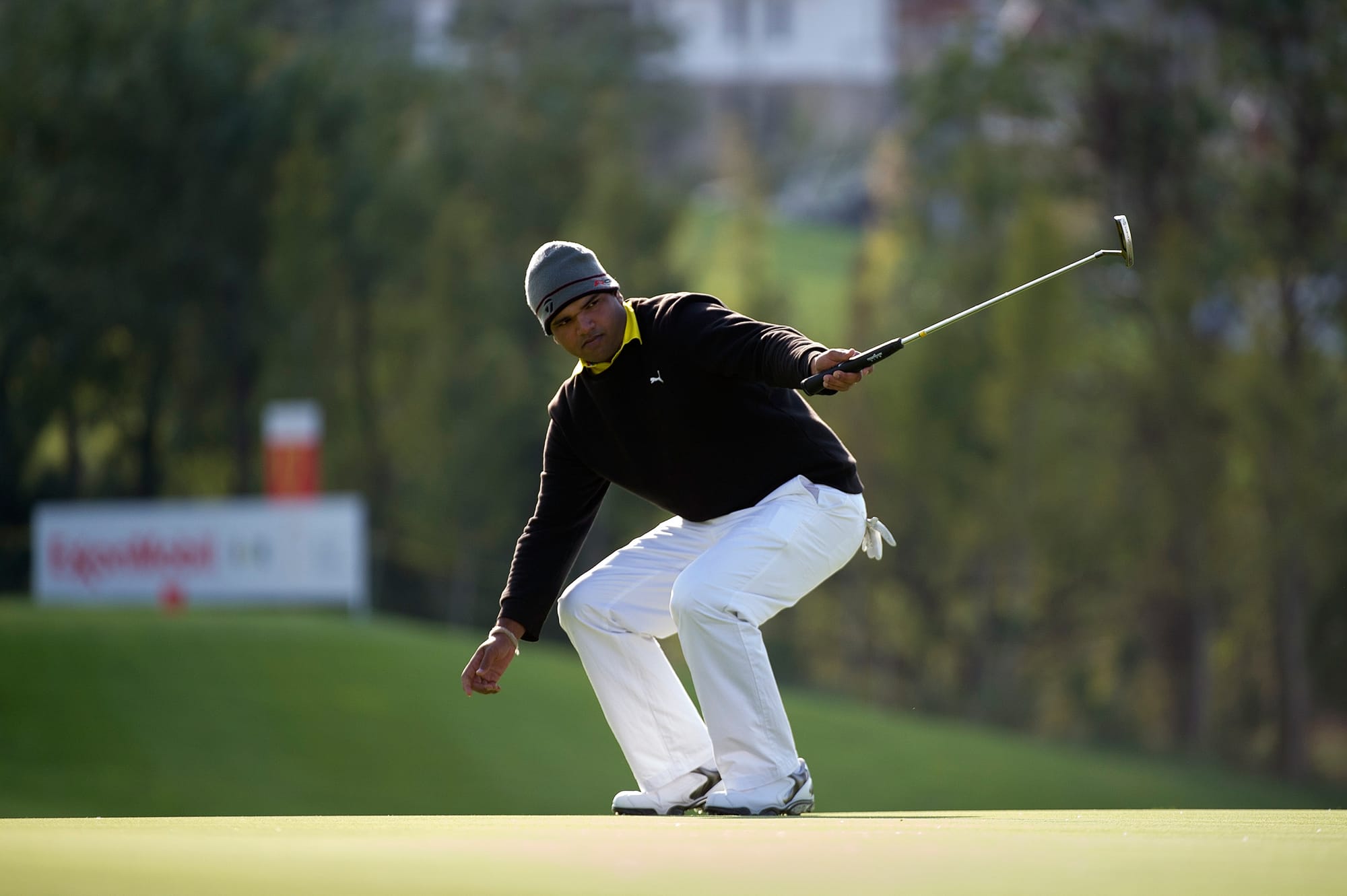 Indian Udayan Mane coaxes a birdie putt into the hole en route to a joint 39th-place finish.