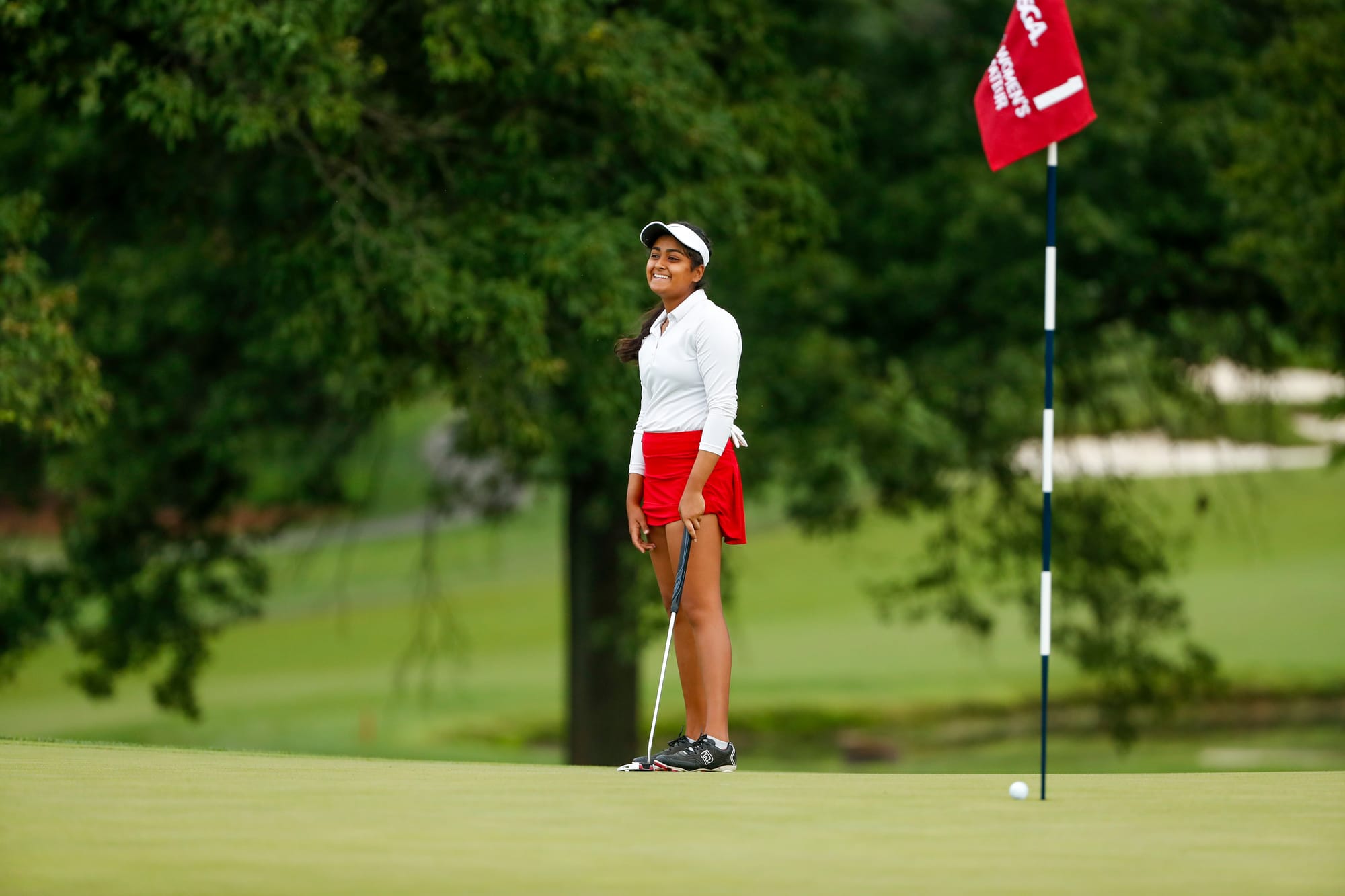 The first Indian to play the US Women’s Amateur, Anika Varma smiles ruefully after seeing a putt fail to drop. She missed qualifying for match play by one stroke. Picture by Chris Keane/USGA.