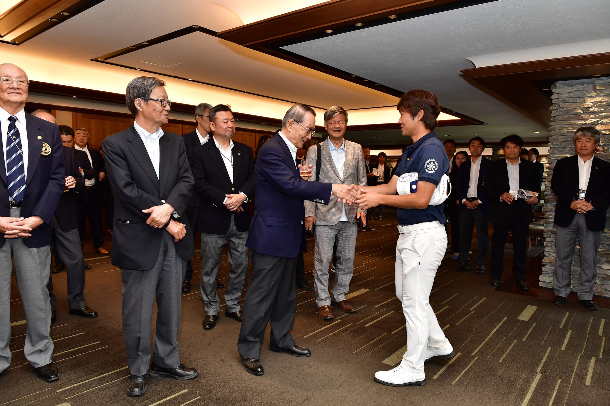 Yosuke Asaji was the centre of attention at a post-event cocktail function.