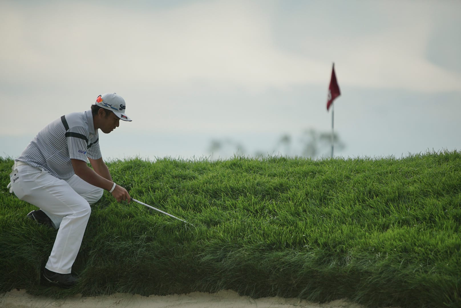 Hideki Matsuyama checks out the deep rough at Winged Foot. Picture by Jeff Marsh/USGA.