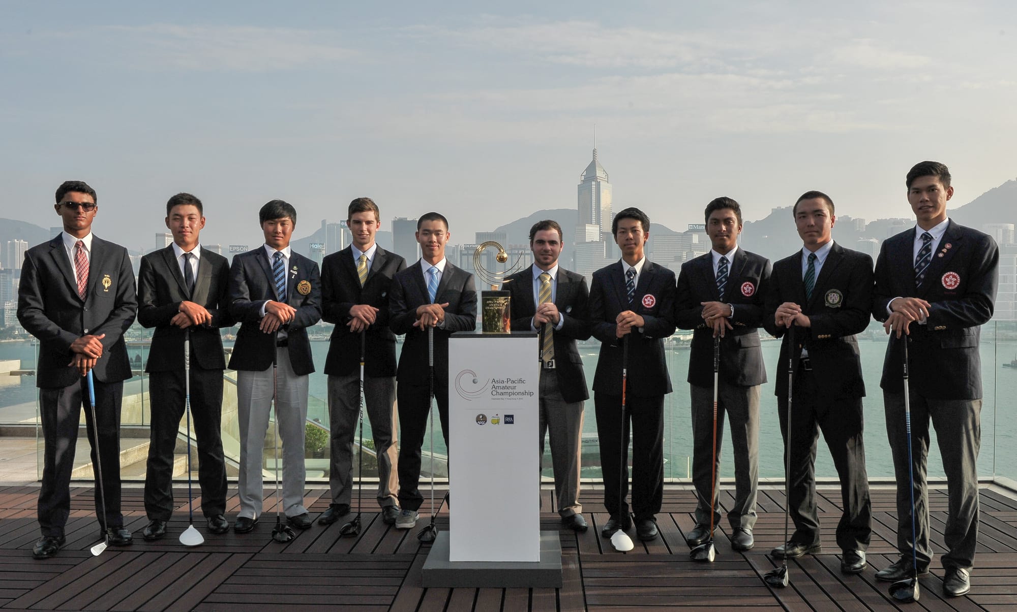 Swapping their golf gear for jackets and ties, pre-tournament favourites took part in a photo shoot alongside Hong Kong harbour.