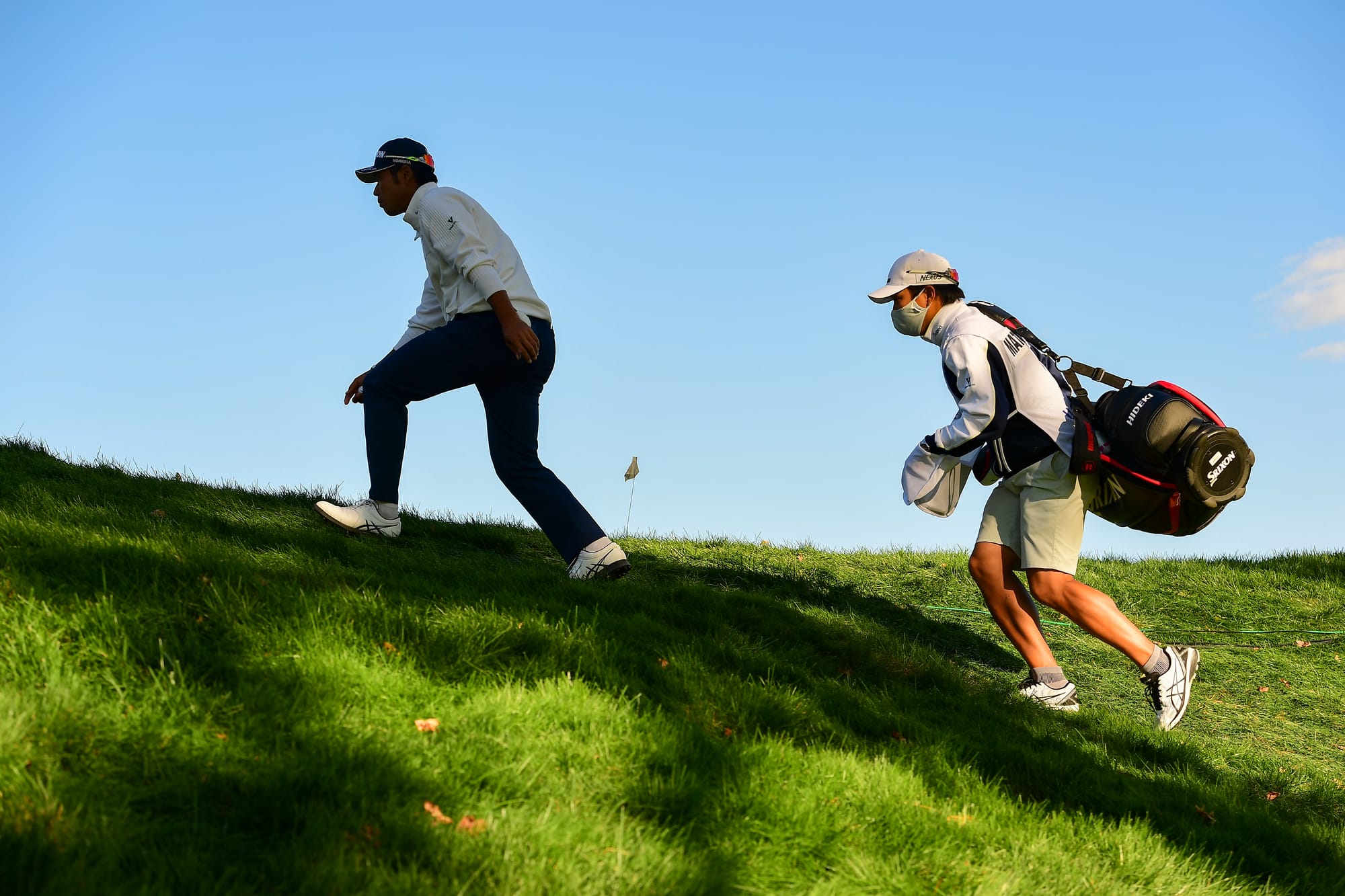 Hideki Matsuyama and his caddie Shota Hayafuji walk to the 17th tee. Picture by Robert Beck/USGA.