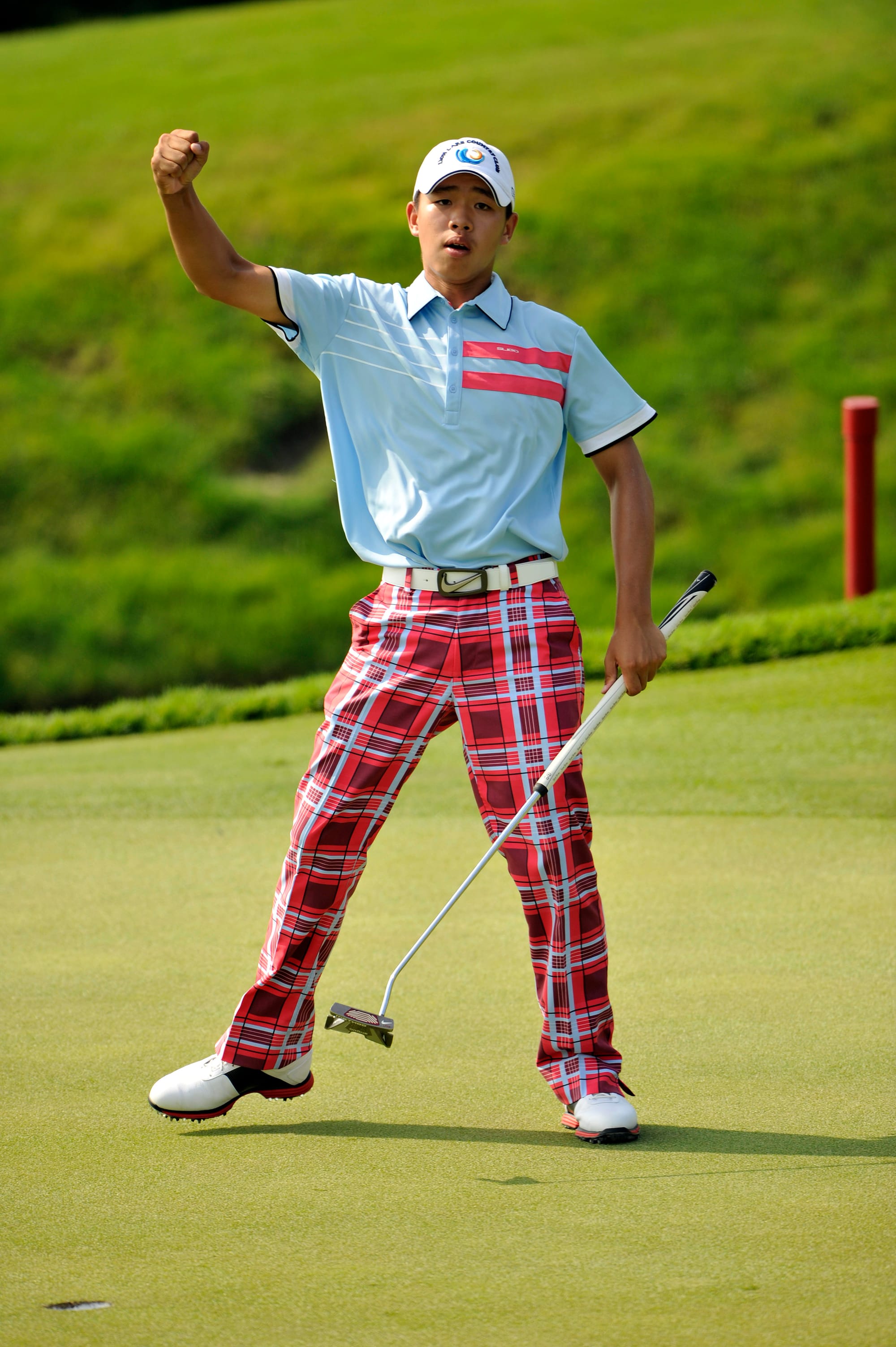 Guan Tianlang reacts after holing the winning putt.